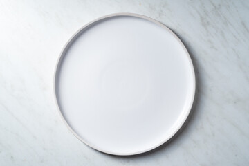 Empty white plates on white kitchen table. Overhead view.