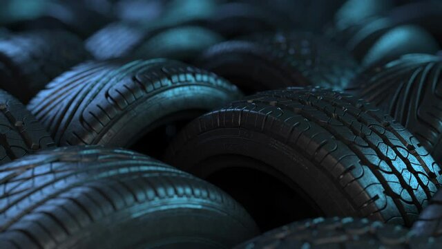 Car tires in elegant studio lighting. The film is looped, arranged in an interesting way in a warehouse or store, the background of the car industry.