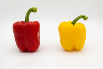 Red and yellow paprika on the white background.