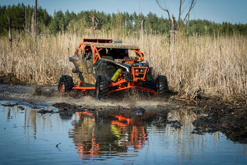ATV and UTV riding in hard track with mud splash. Amateur competitions. 4x4.