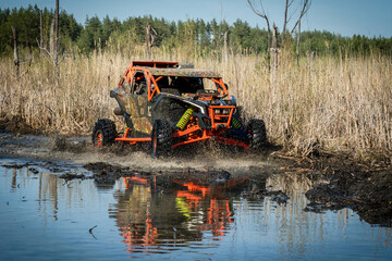 ATV and UTV riding in hard track with mud splash. Amateur competitions. 4x4. © Antonio