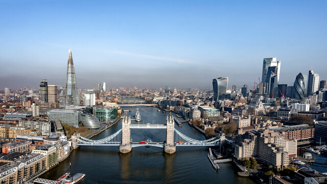 London City, tower bridge, The Shard and River Thames. Aerial view at looking over tower bridge towards the city in bright sunlight. 