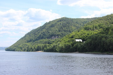 Zhiguli mountains, overgrown with green forest, on the bank of the Volga River - view from the ship