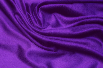 Fototapeta na wymiar Close-up texture of natural violet or purple fabric or cloth in same color. Fabric texture of natural cotton, silk or wool, or linen textile material. Violet or purple canvas background pattern.