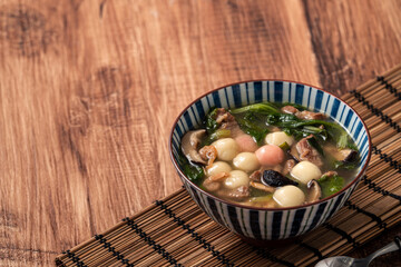 Red and white tangyuan with savory soup.