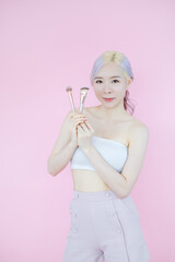 posing beautiful asia woman posing on pink background, emotions action, beauty concept