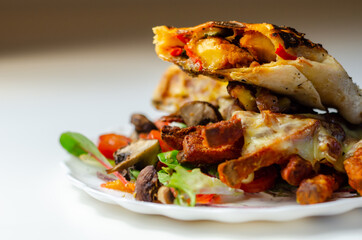 Grilled tortilla wrap with southern style chicken breast with sweet potato fries served on the mix salad