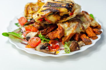 Grilled tortilla wrap with southern style chicken breast with sweet potato fries served on the mix salad