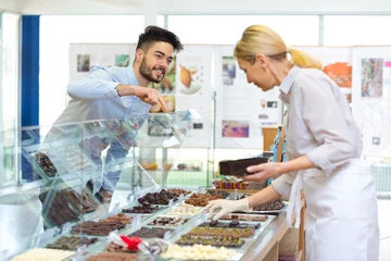 Foto op Plexiglas tourist buying different belgian chocolates © auremar