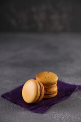 Yellow macaroons on a gray background