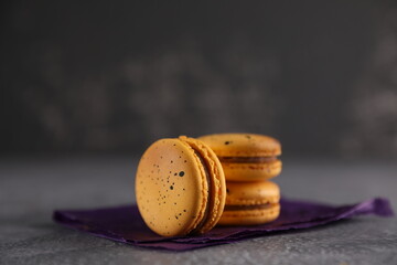 Yellow macaroons on a gray background