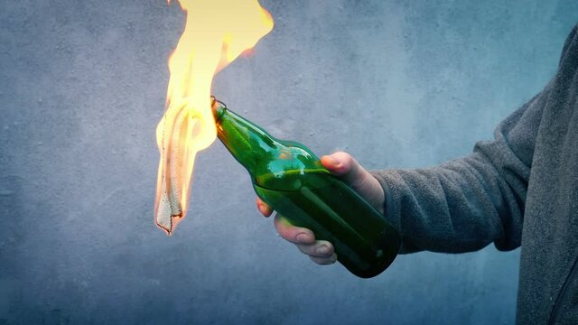 Gasoline Bottle Lit And Thrown With Fire Lighting Up Wall
