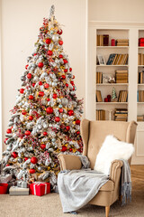 Cozy decor for Christmas and New Year. New Year's concert. Christmas photo. A photo zone with Christmas landscapes: a Christmas tree, gifts, an armchair with pillows and bookshelves.