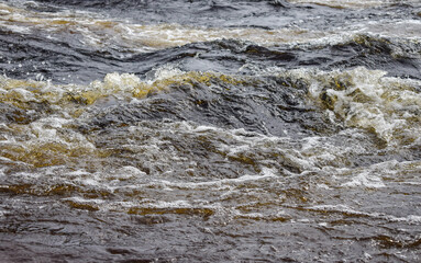 The clear water in the river boils and foams.