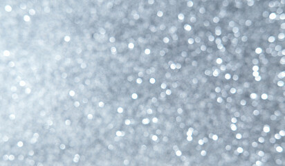 White, silver, gray Christmas background with defocused lights. Background for Valentine's Day. White or silver lights on a silver background.