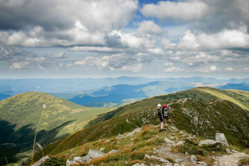 Fototapeta premium Hiker on the top in Carpathians mountains. Travel sport lifestyle concept.