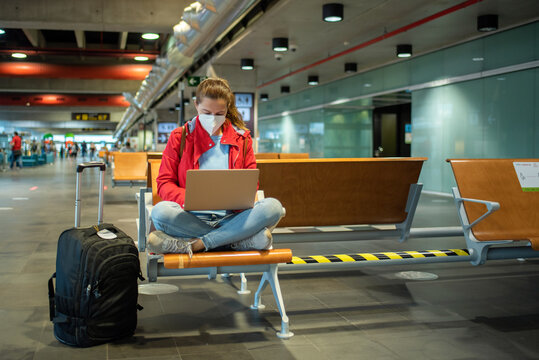 Woman browsing laptop in airport