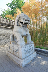 The ancient stone lion is in a park, Beijing