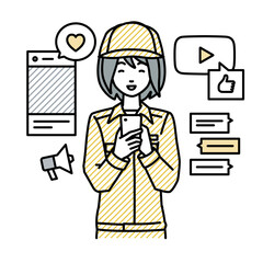 立ってスマートフォンでさまざまなSNSで楽しく交流する作業員の女性