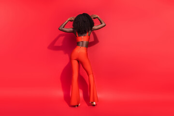 Full size rear behind photo of young lady dancing enjoy entertainment wear stilettos isolated on...