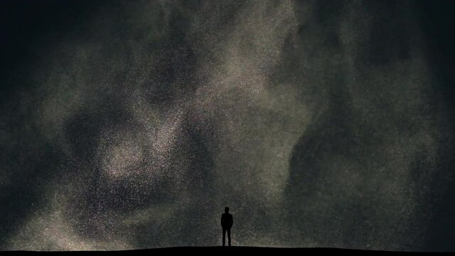 The man stands on snow falling background