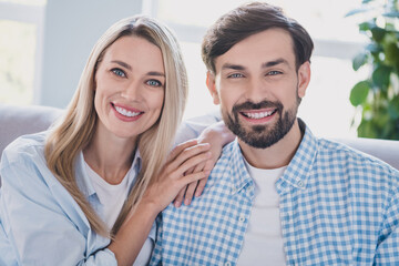 Photo of cheerful couple in love look camera hug beaming smile wear casual outfit in comfortable home indoors