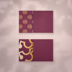 Burgundy business card with abstract gold pattern for your personality.