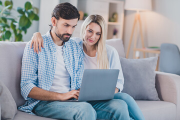 Photo of confident two people sit divan typing surf internet wear casual outfit in comfortable home indoors