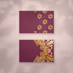 Burgundy business card with Indian gold pattern for your brand.
