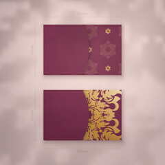 Burgundy business card with Indian gold pattern for your business.
