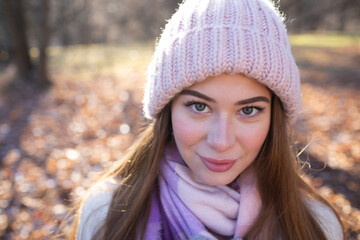Portrait of a beautiful young woman in a knitted hat