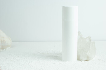 Bottle of cream on a white background with crystal