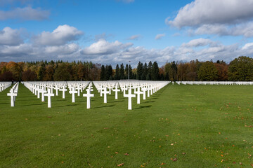 Neupre, Belgium - November 1, 2021: Ardennes American Cemetery and Memorial. Many of the burial are from the Ardennes winter offensive (Battle of the Bulge). Autumn sunny day. Selective focus.