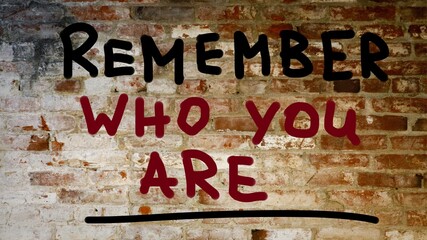 Remember who you are handwritten concept. Graffiti on the wall.