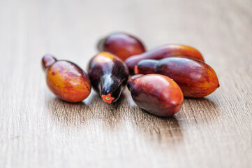 fresh picked multicolored striped and streaky black, purple, and red tomatoes on a wooden table