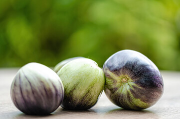 fresh and delicious tomatoes of green-black colored sort on a wooden table, closeup