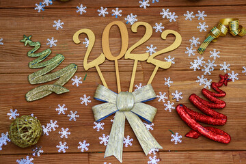 Year 2022, festive background, numbers, wooden table.
