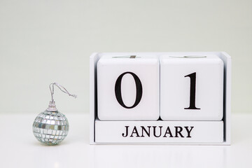 Abstract background, desktop cube calendar with the date - January 1, the designation of the...