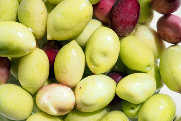 Background from the fruits of the olive tree. Green and black olives