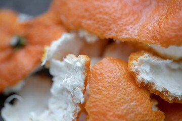 Peeled tangerine peel on a wooden cutting board, orange peel, close-up.
