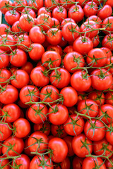 group of red ripe and delicious tomatoes for sale in an urban market in france