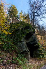 Felsen und Höhle  am Ufer der Schwarzatal in Türingingen mit Bäumen im Herbst