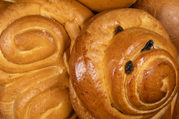 Danish bun and pretzel in the foreground of bakery or pastry composition close-up