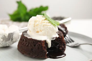 Tuinposter Delicious fresh fondant with hot chocolate, ice cream  and mint served on plate, closeup © New Africa
