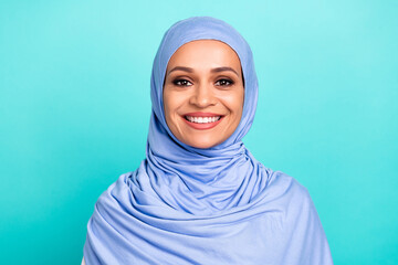 Photo of pretty adorable young woman wear arab headscarf smiling isolated turquoise color background