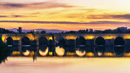 Fototapeta na wymiar Roman bridge across the Guadalquivir river at sunset in the medieval city of Cordoba, Andalusia.