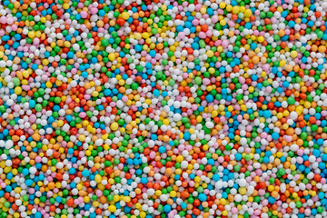 Thousands sprinkles tiny sugar beads for decorating cakes and desserts background.