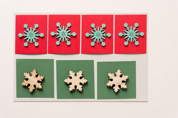 set of wooden snowflake shapes on paper squares