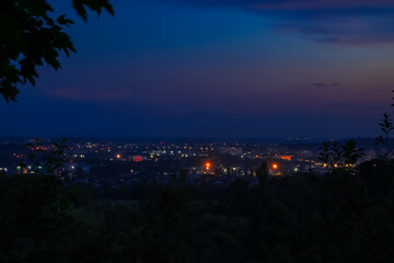 abstract unfocused fuzzy city lights illumination in twilight time after sunset foreshortening from suburban district hill top point