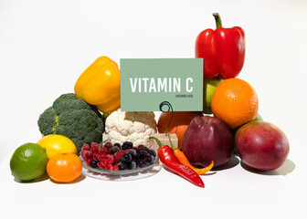 A set of natural products rich in vitamin C ascorbic acid. Healthy food concept. Cardboard sign with the inscription.